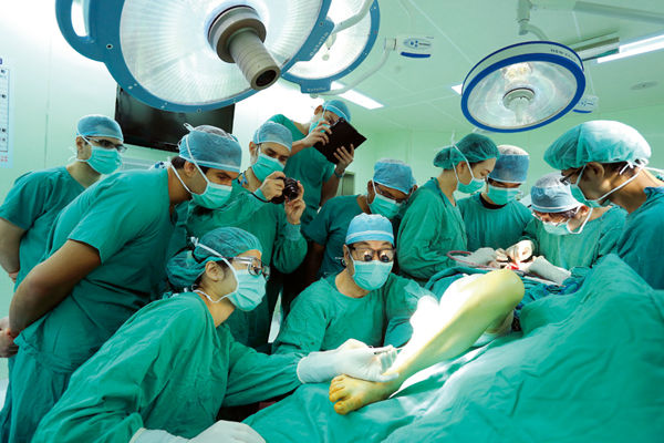 Foreign doctors gather round as Wei conducts his teaching outpatient clinic.